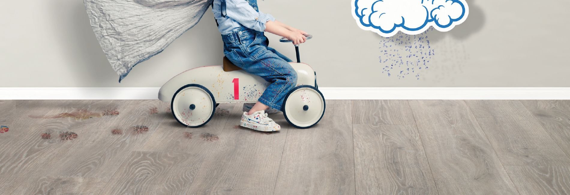 Toddler playing on Revwood resistance hardwood flooring.